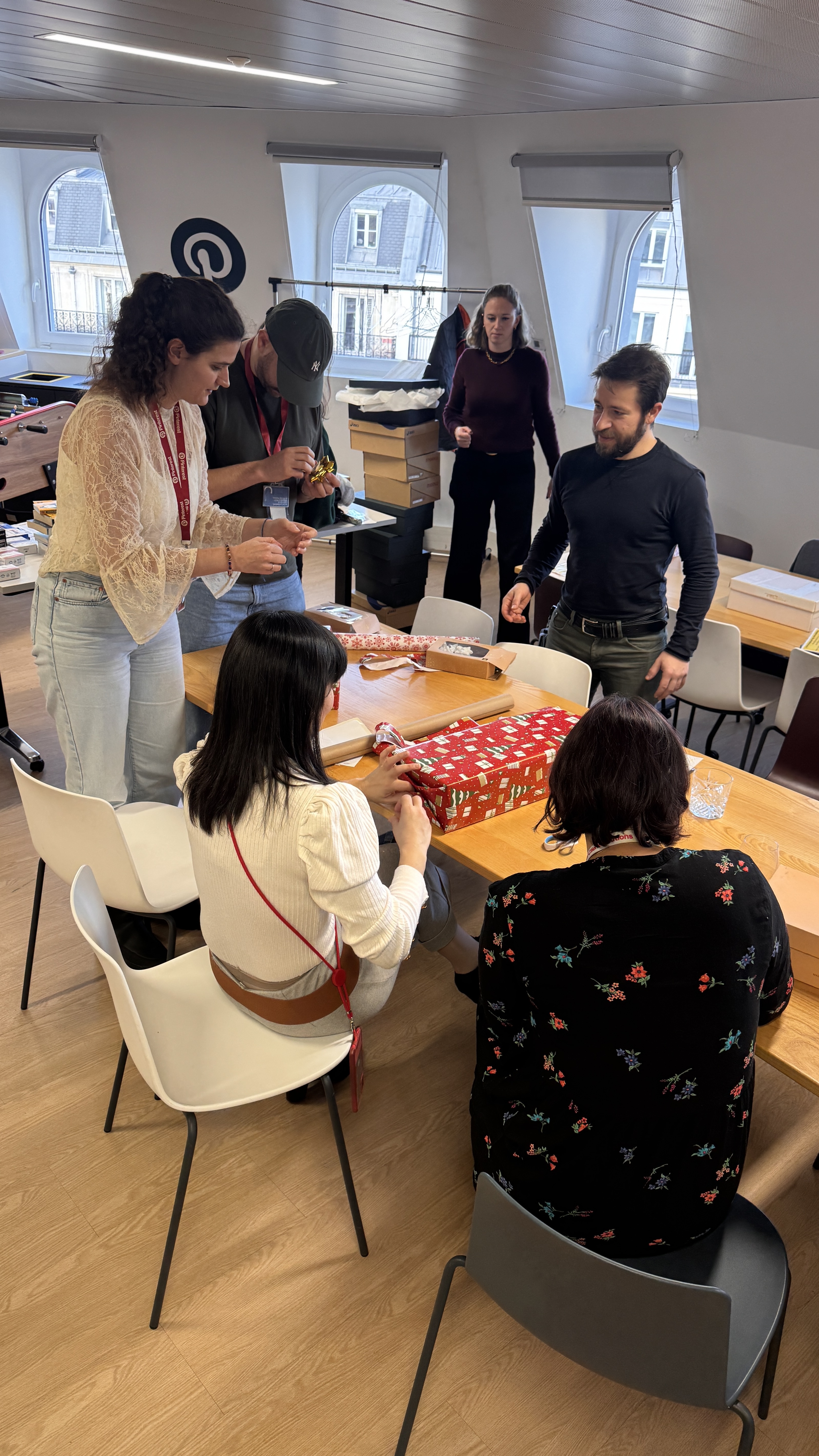 a group of people around a table with presents