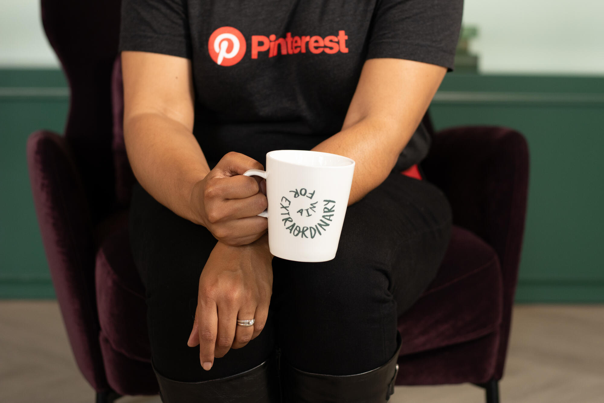 a person holding a white mug
