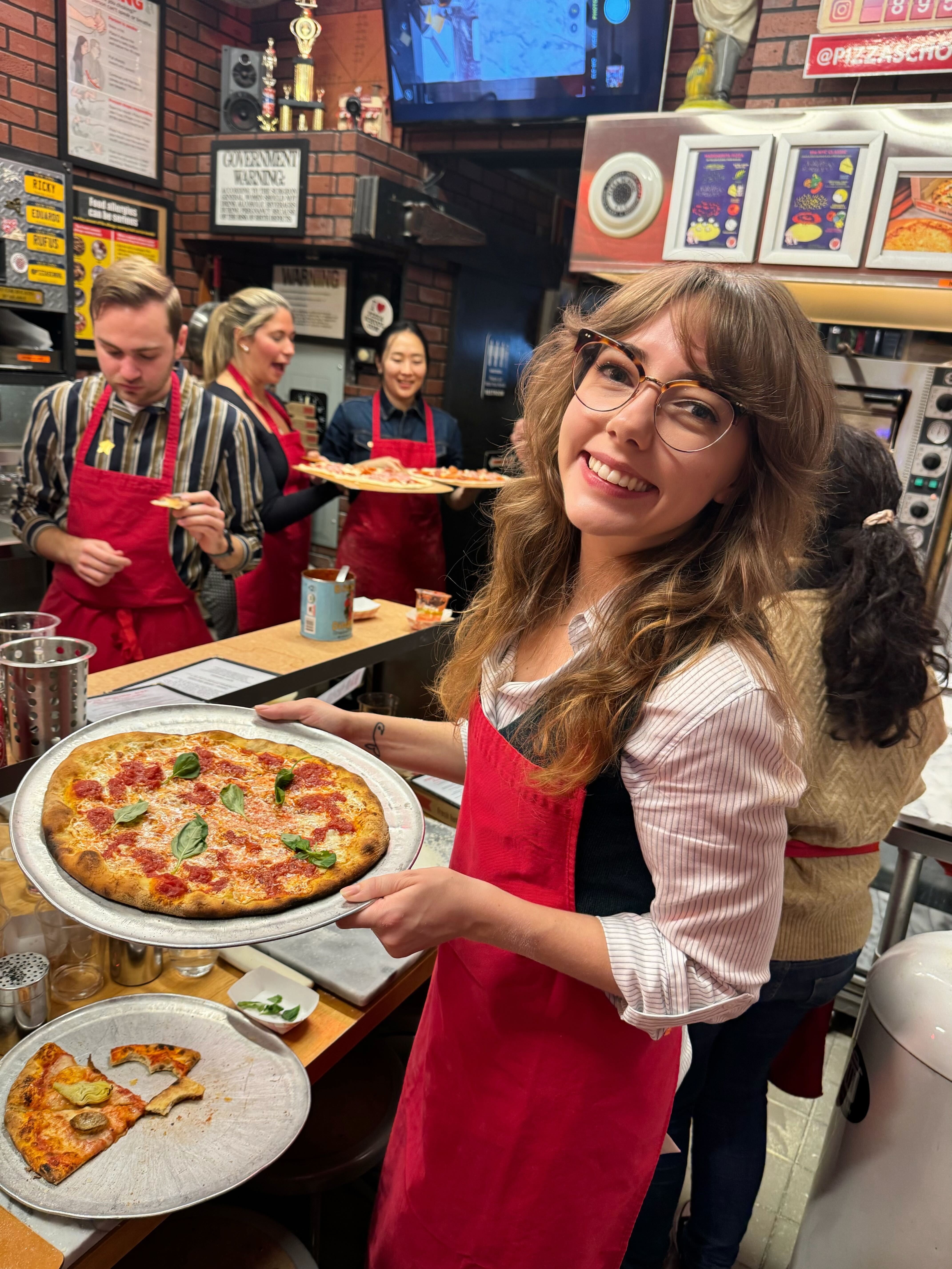 a person holding a pizza