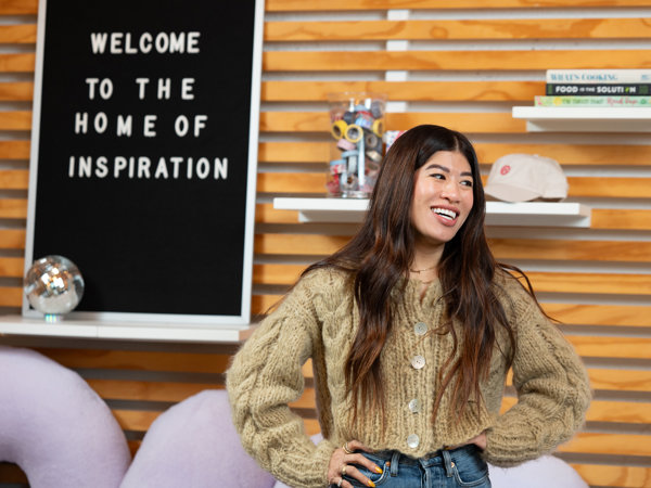 a woman smiling with her hands on her hips