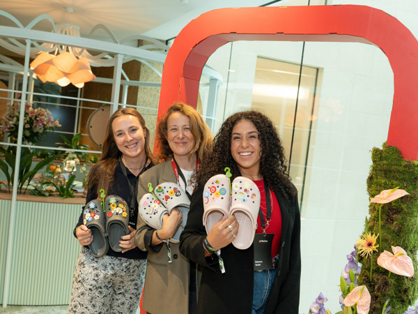 a group of women holding slippers
