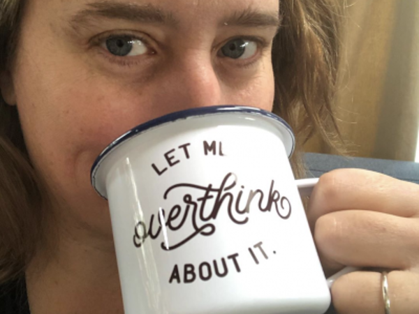 a woman drinking from a mug