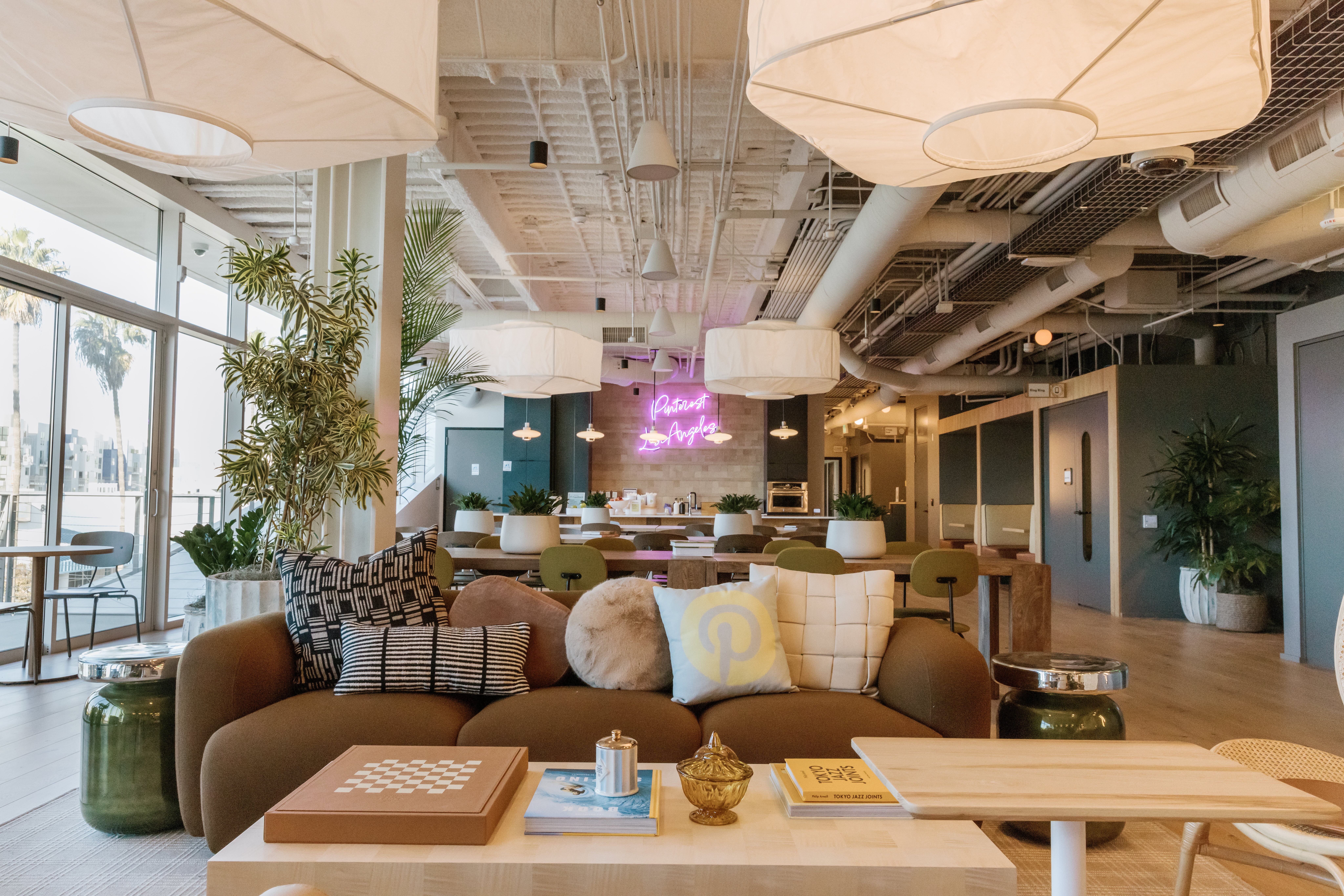 a room with a couch and tables and lamps