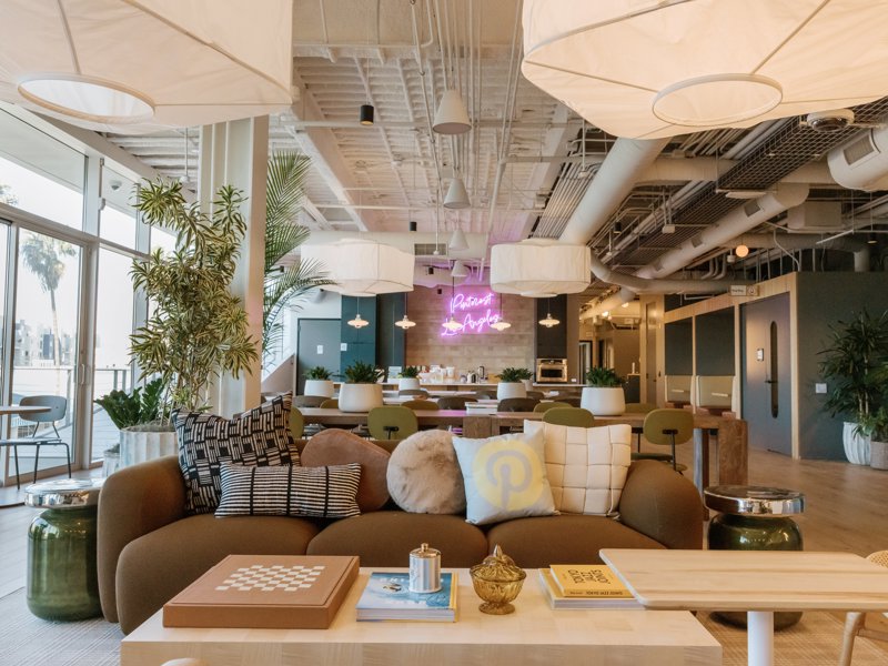 a room with a couch and tables and lamps