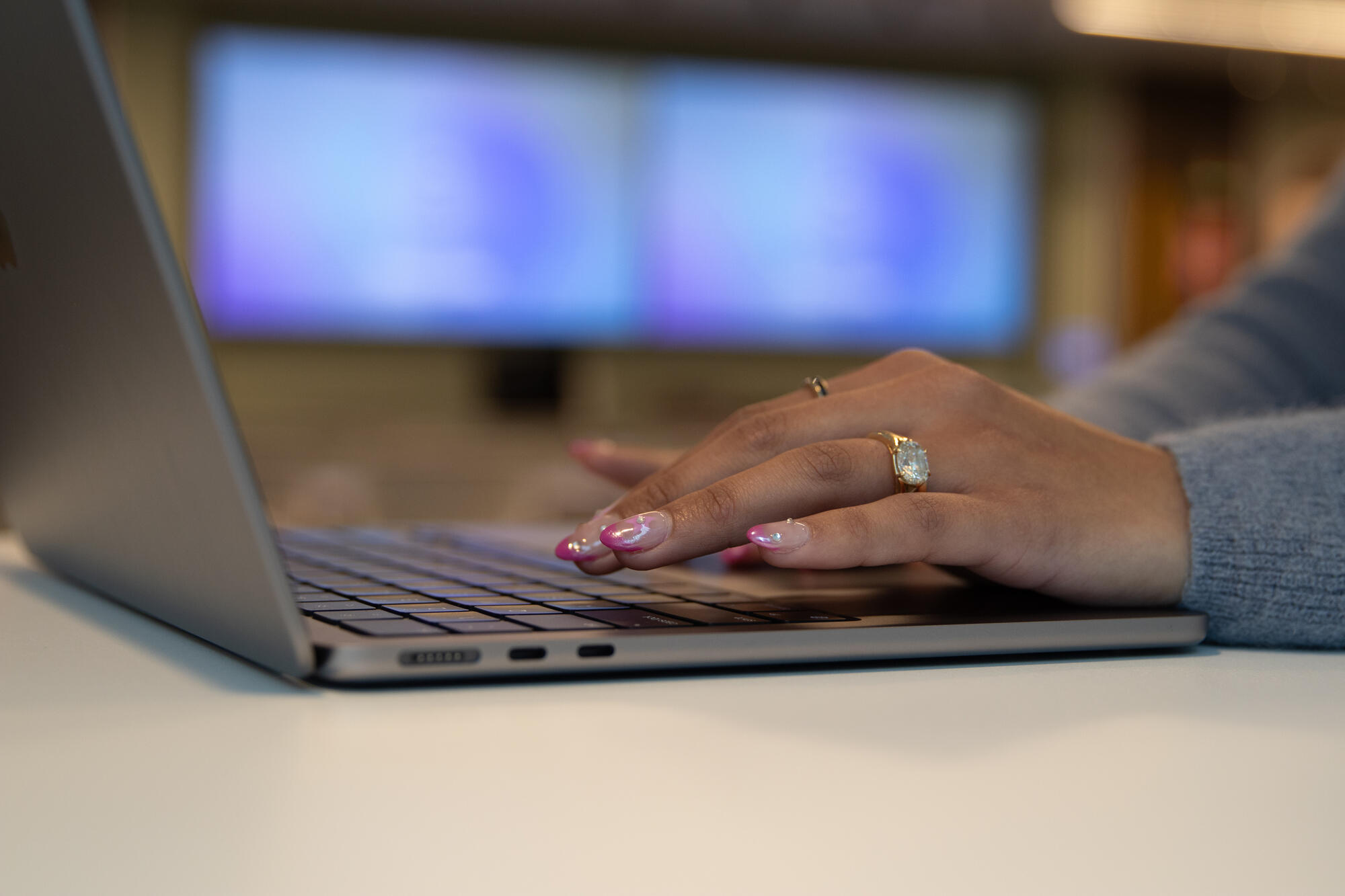 a hand on a laptop keyboard