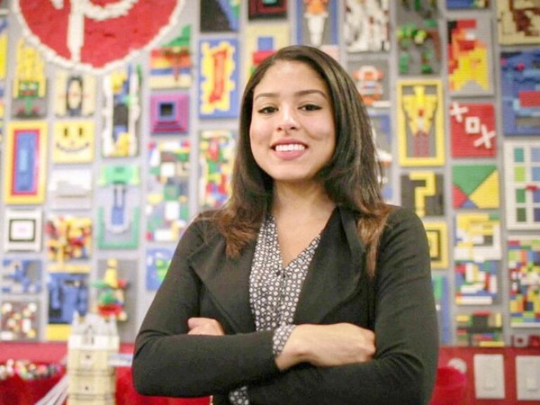 a woman smiling with her arms crossed