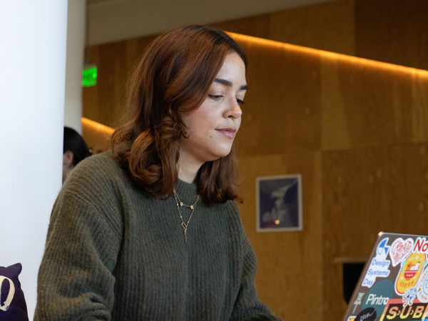 a woman looking at a laptop