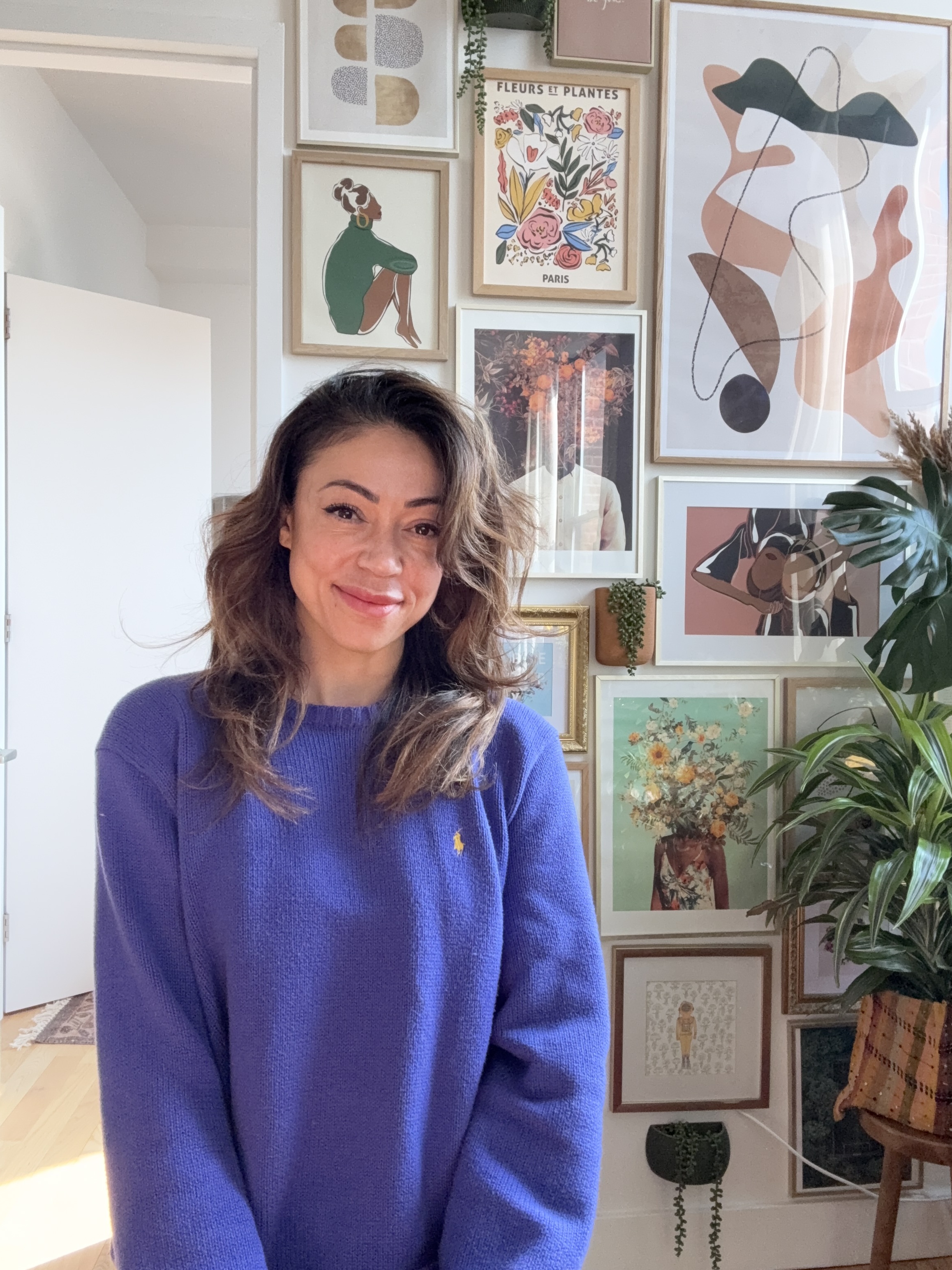 a person standing in front of a wall of art