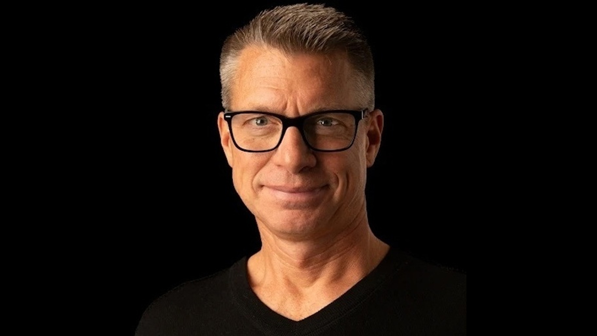a person wearing glasses and a black shirt