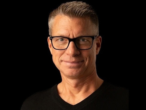 a person wearing glasses and a black shirt