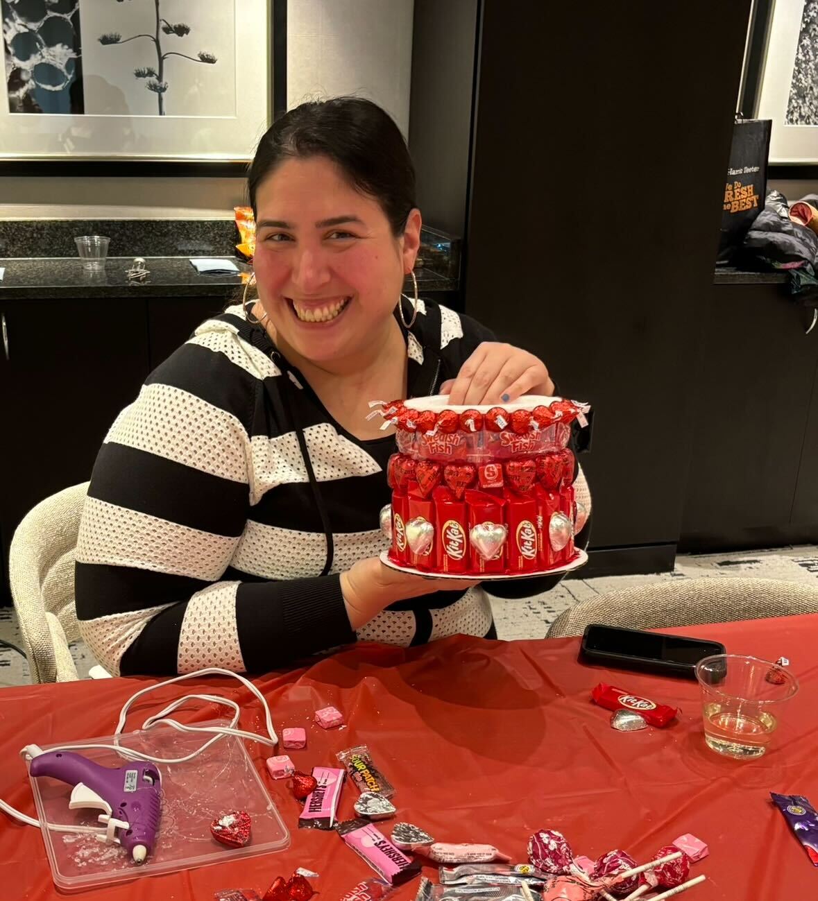 a woman smiling at a table with a cake