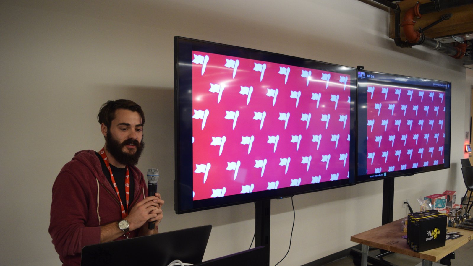 a man holding a microphone in front of a screen