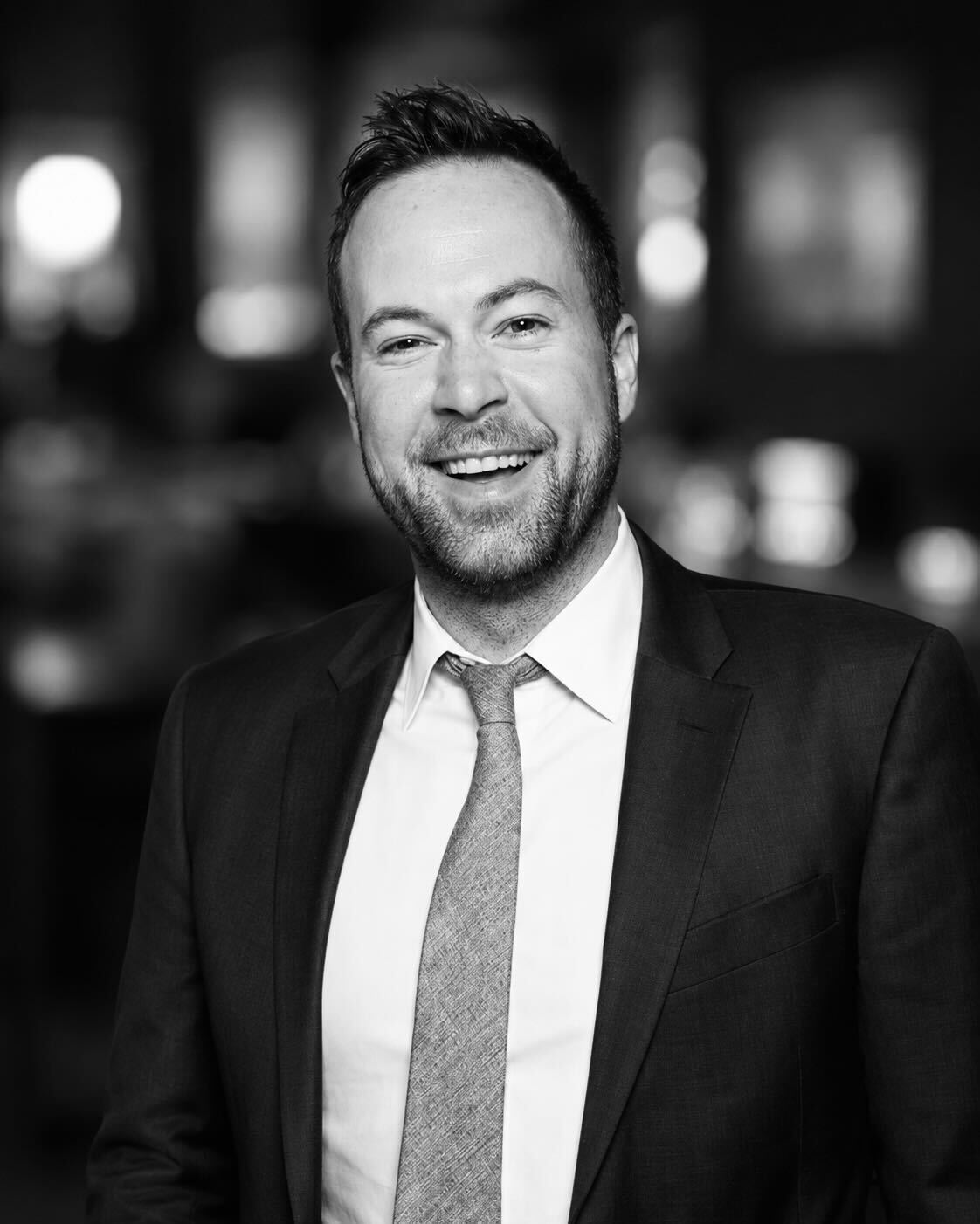 a person in a suit smiling