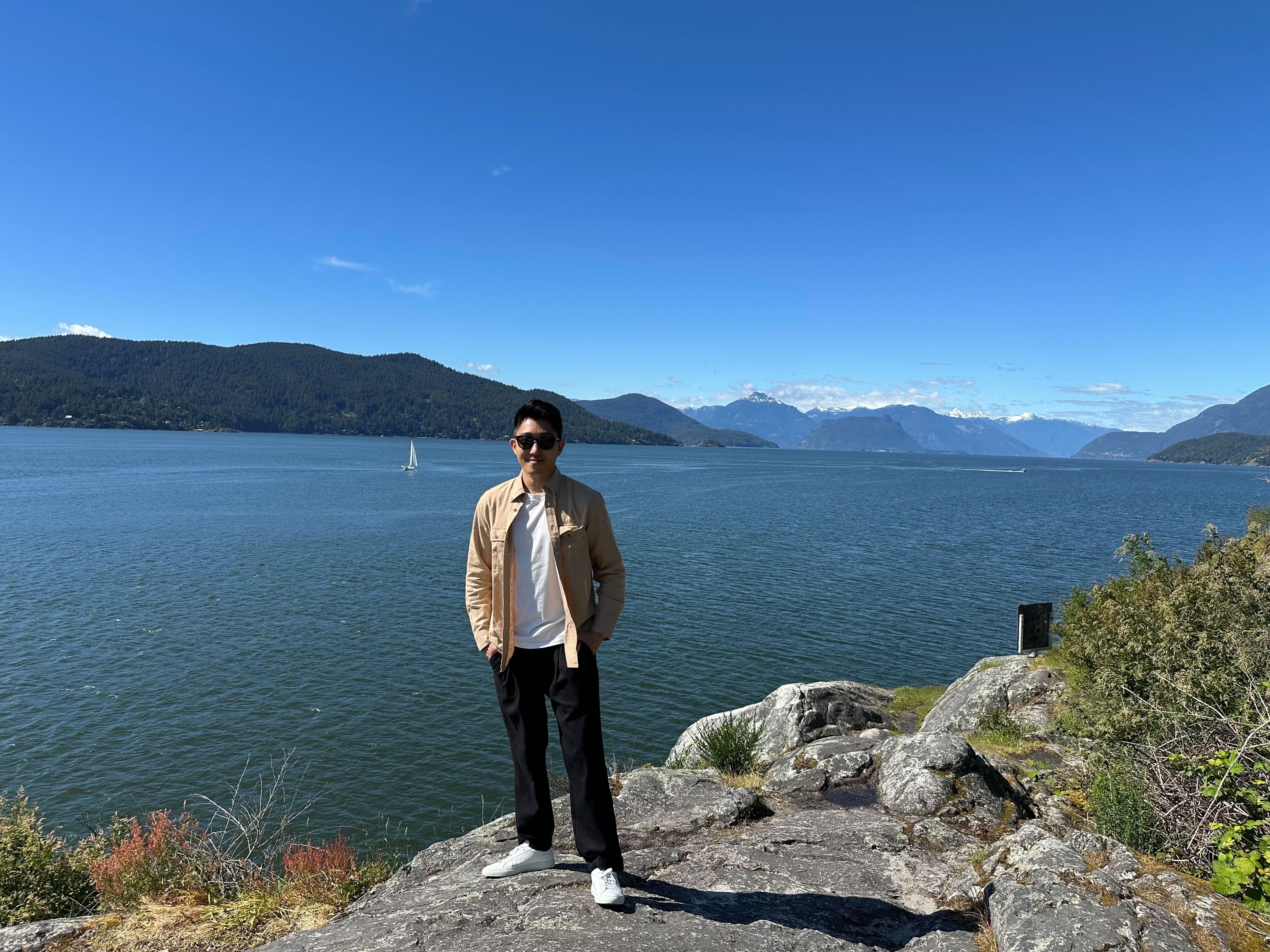 a person standing on a rock near water