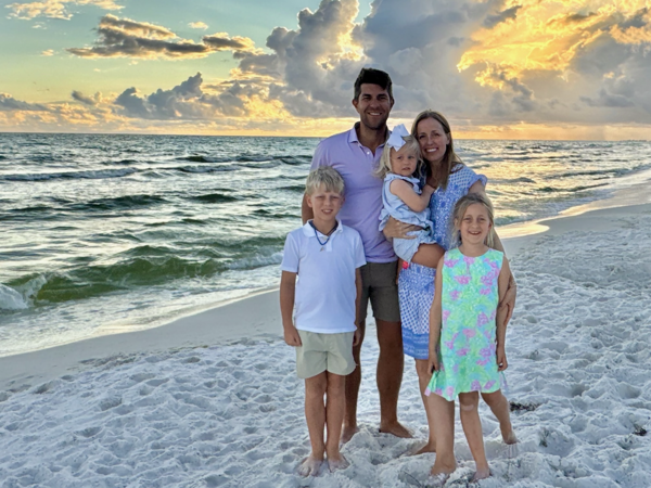 a person and person with children on a beach