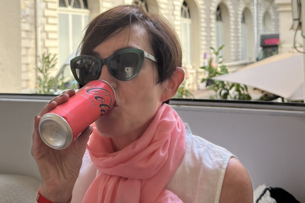 a person drinking from a can