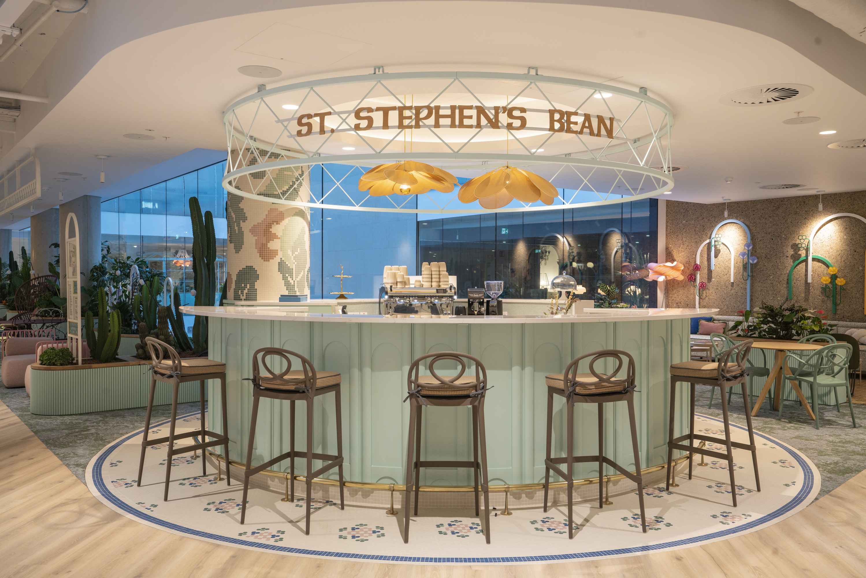 a bar with chairs and a sign above it