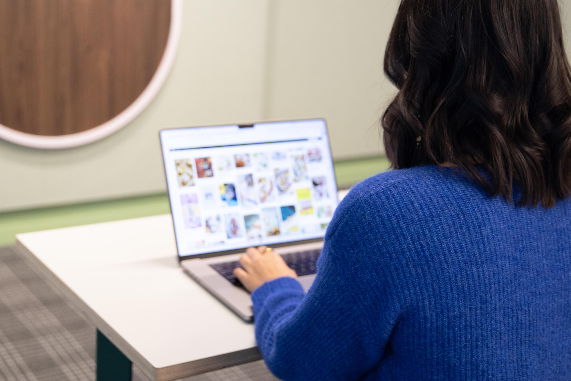 a person sitting at a table using a laptop