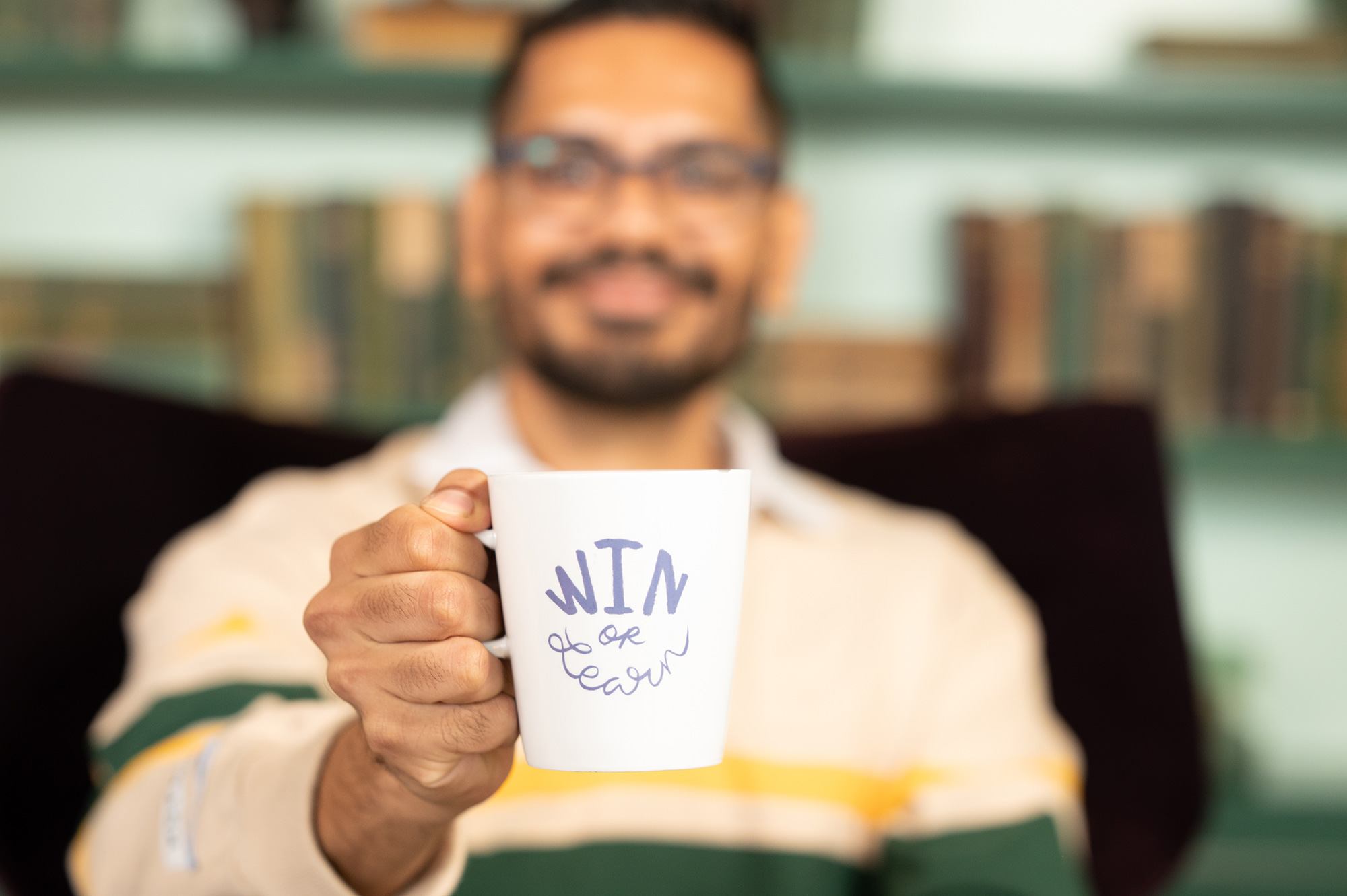 a man holding a white mug