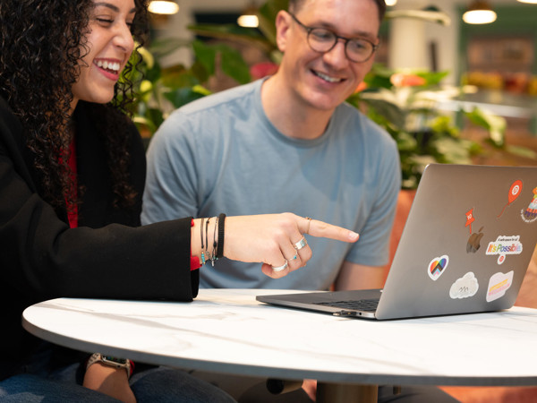 a person and person looking at a laptop