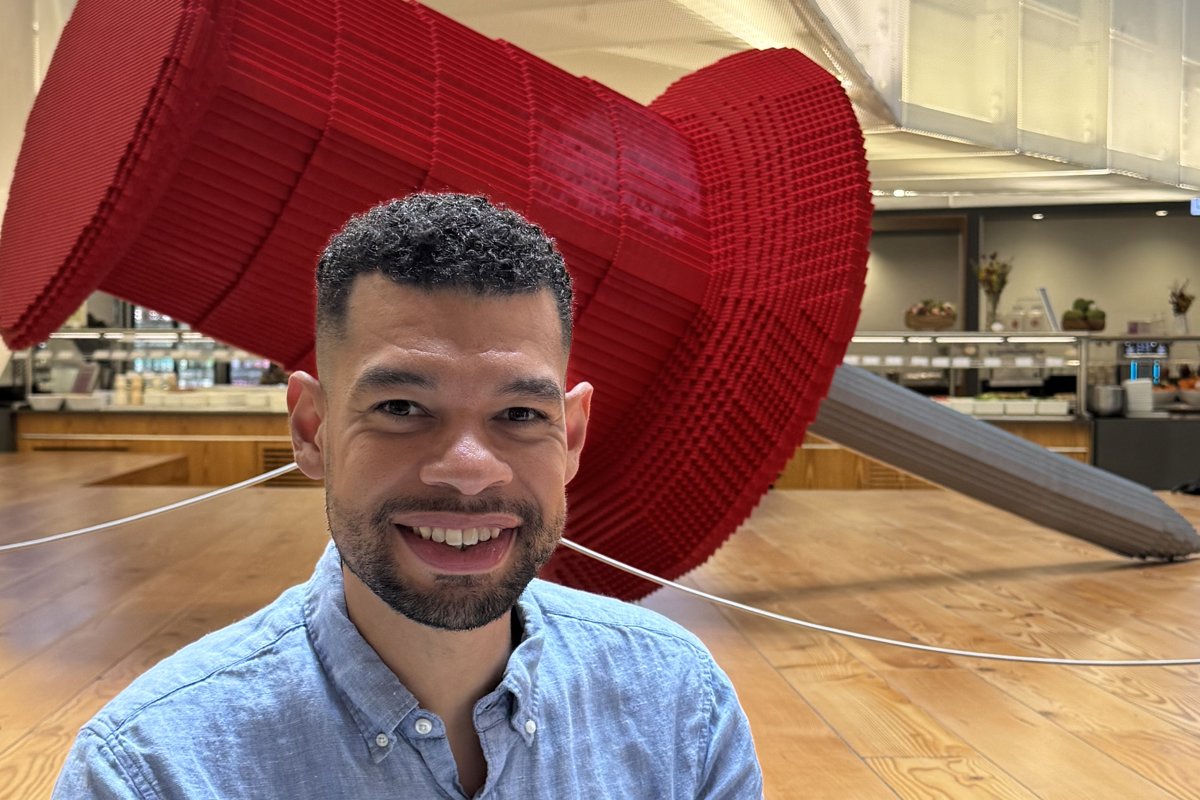 a person sitting in front of a large red object