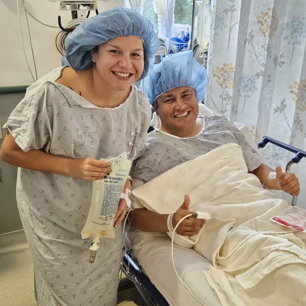 a person and person in hospital gowns and hair caps smiling