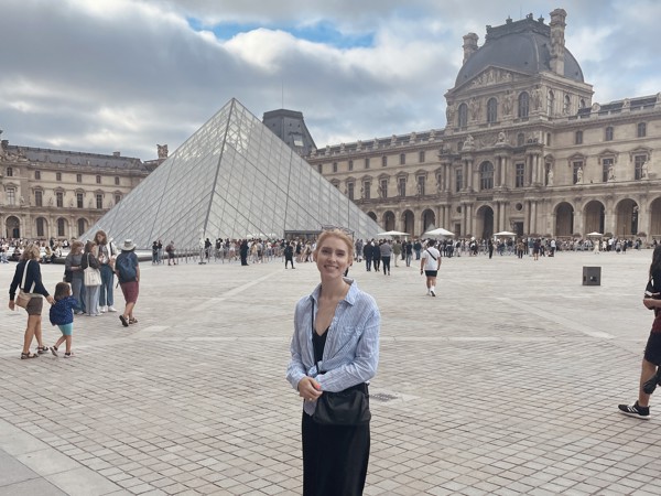 a person standing in front of a pyramid