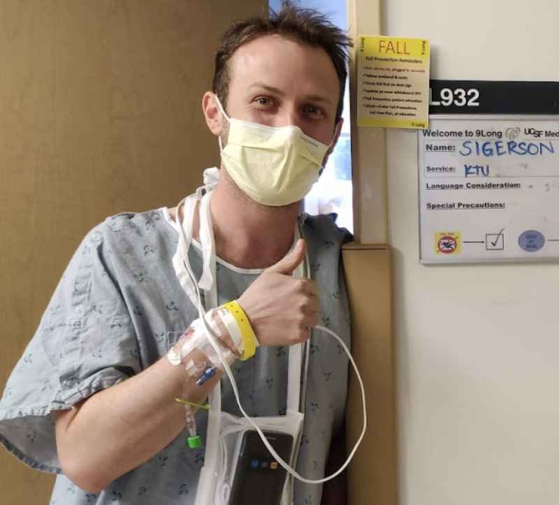 a man wearing a mask and holding a iv tube