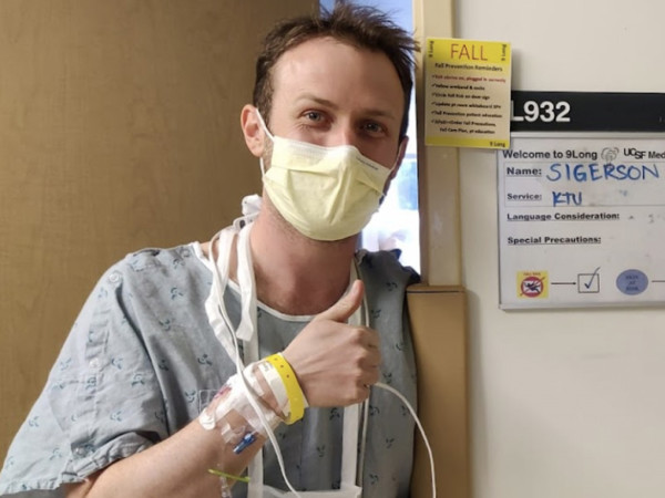 a man wearing a mask and holding a iv tube