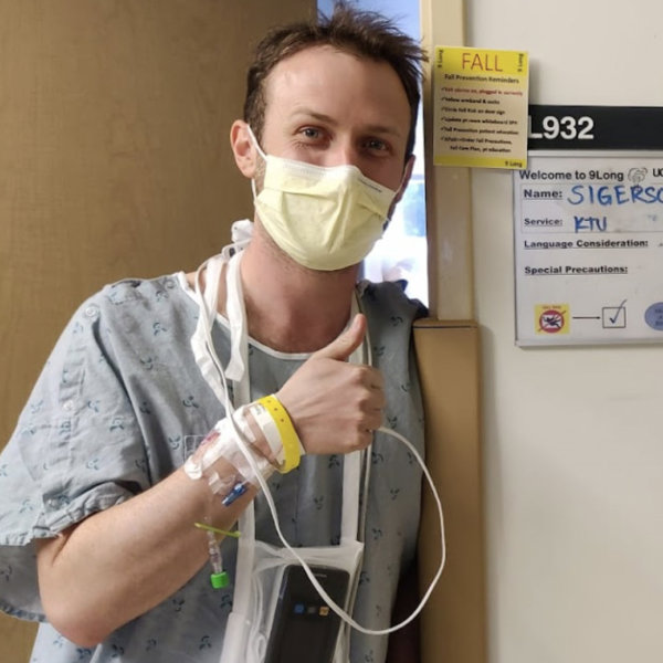a man wearing a mask and holding a iv tube