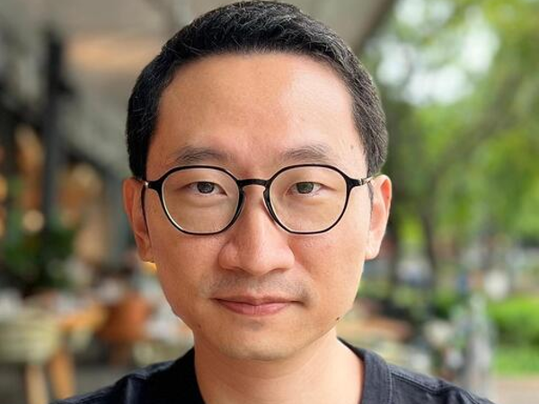 a person wearing glasses and a black shirt