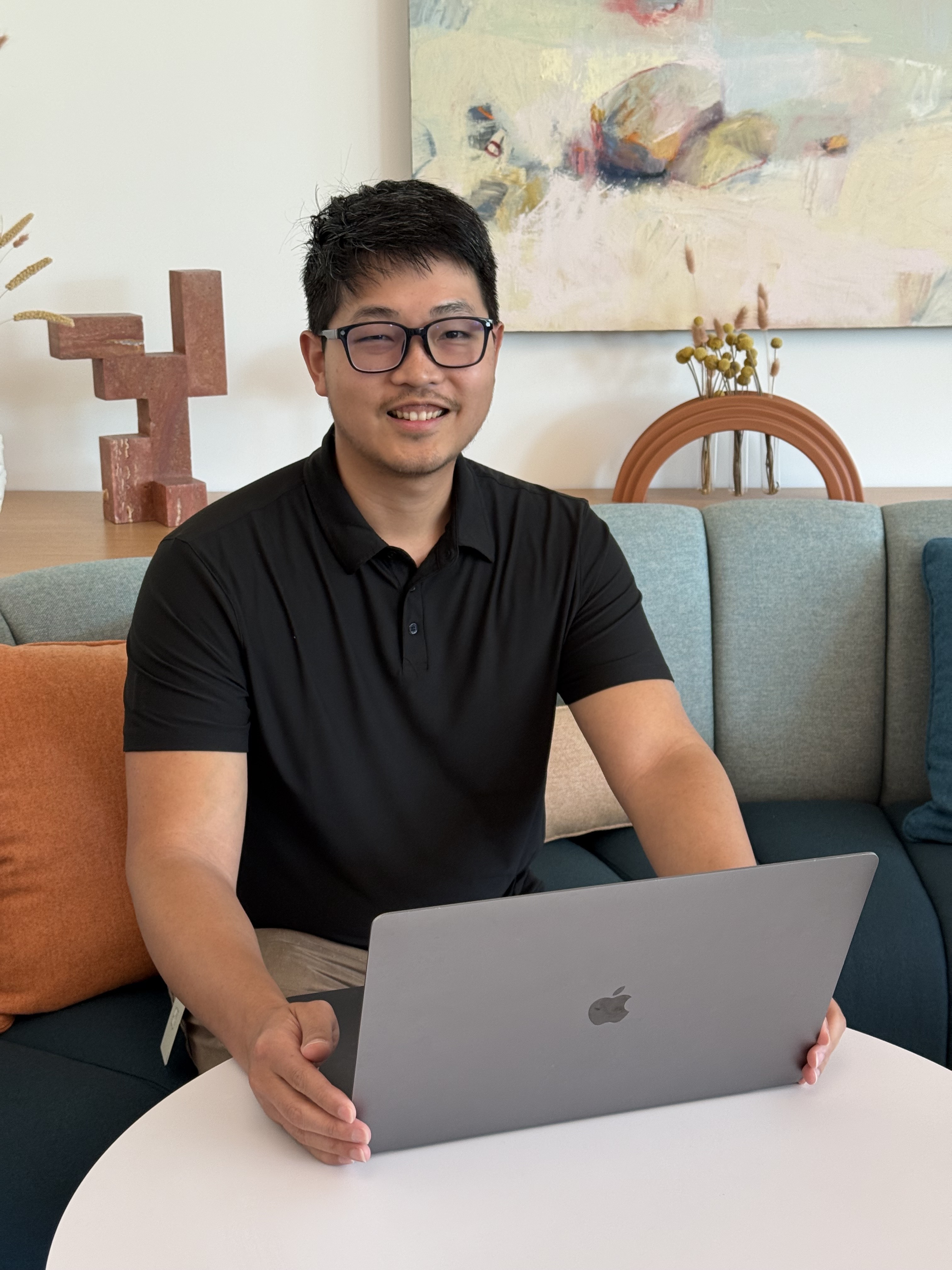 a person sitting on a table with a laptop