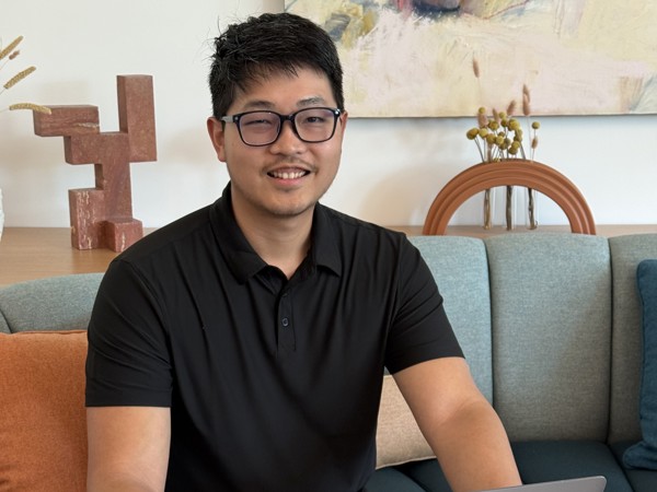 a person sitting on a table with a laptop