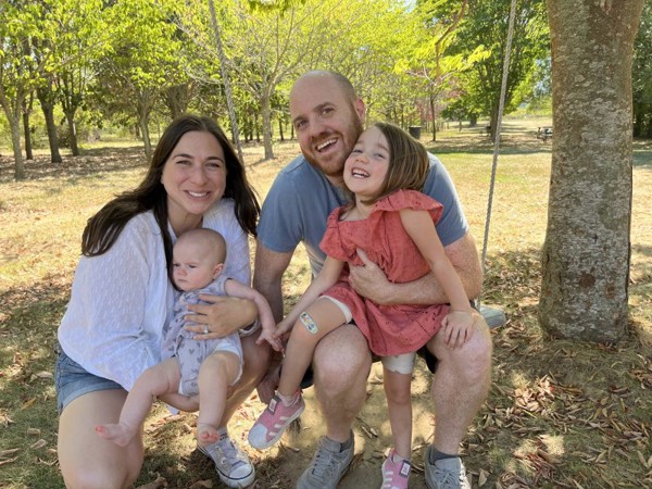 a man and woman with two children