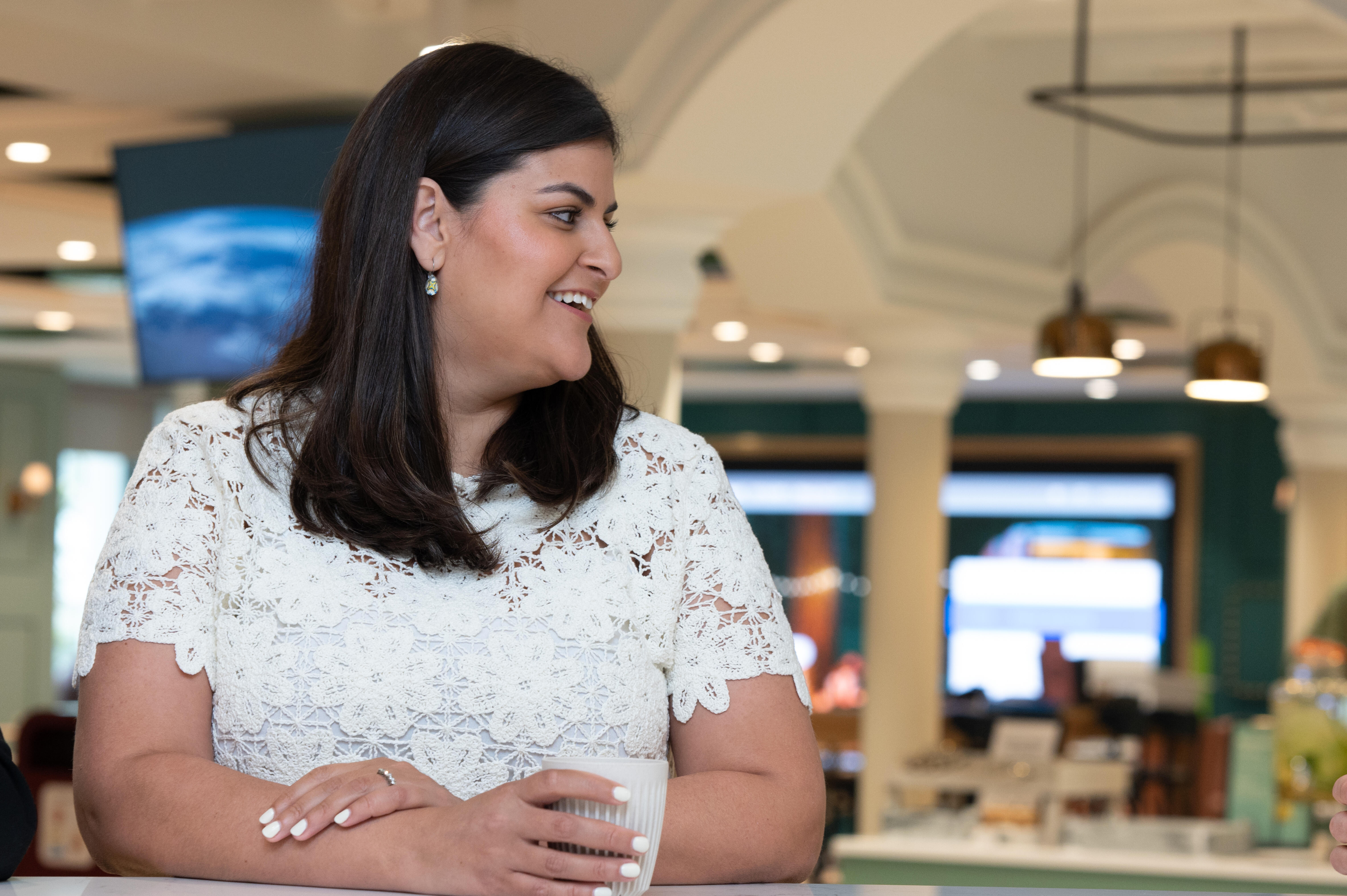 a person smiling at a table