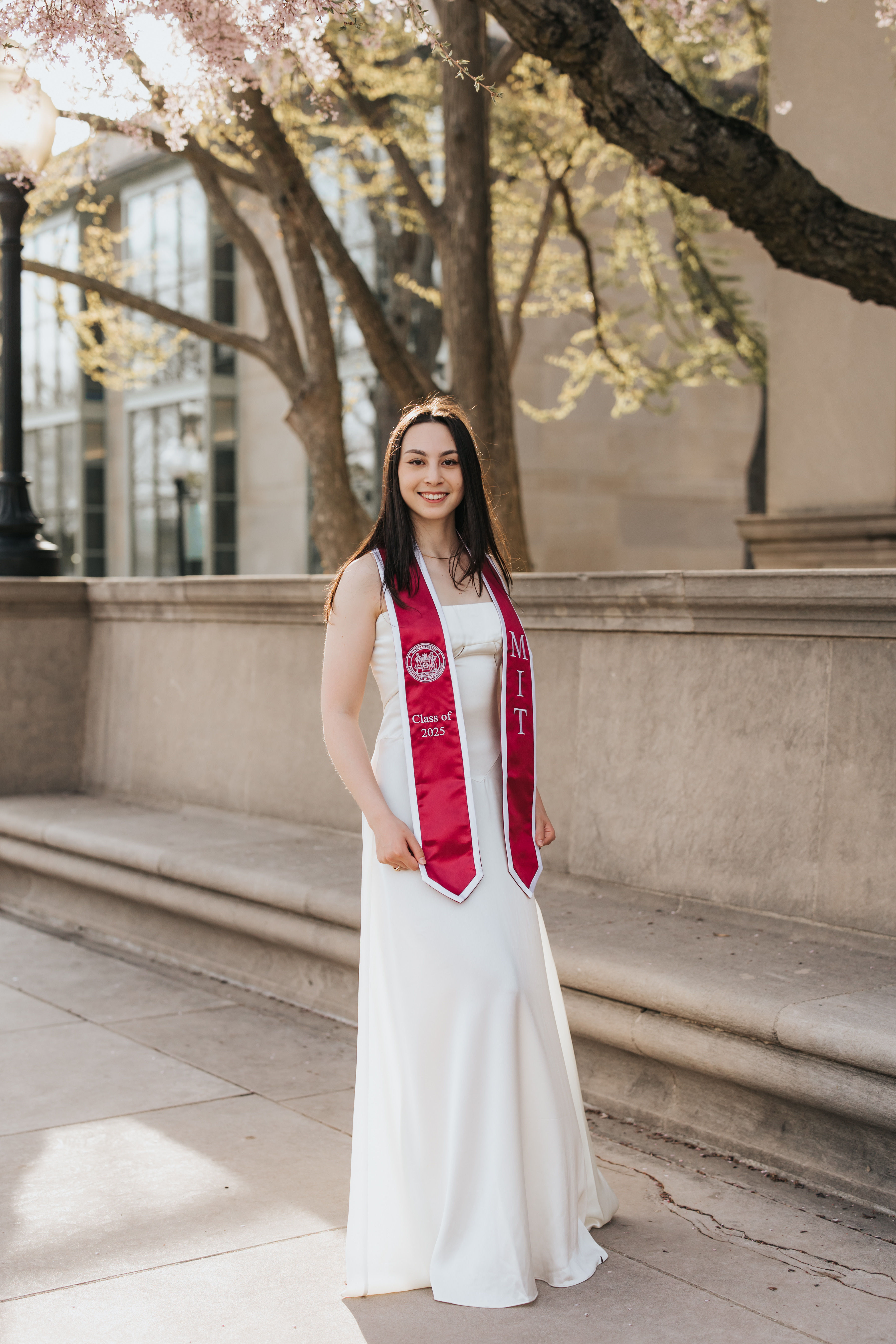 a person in a white dress with a red sash