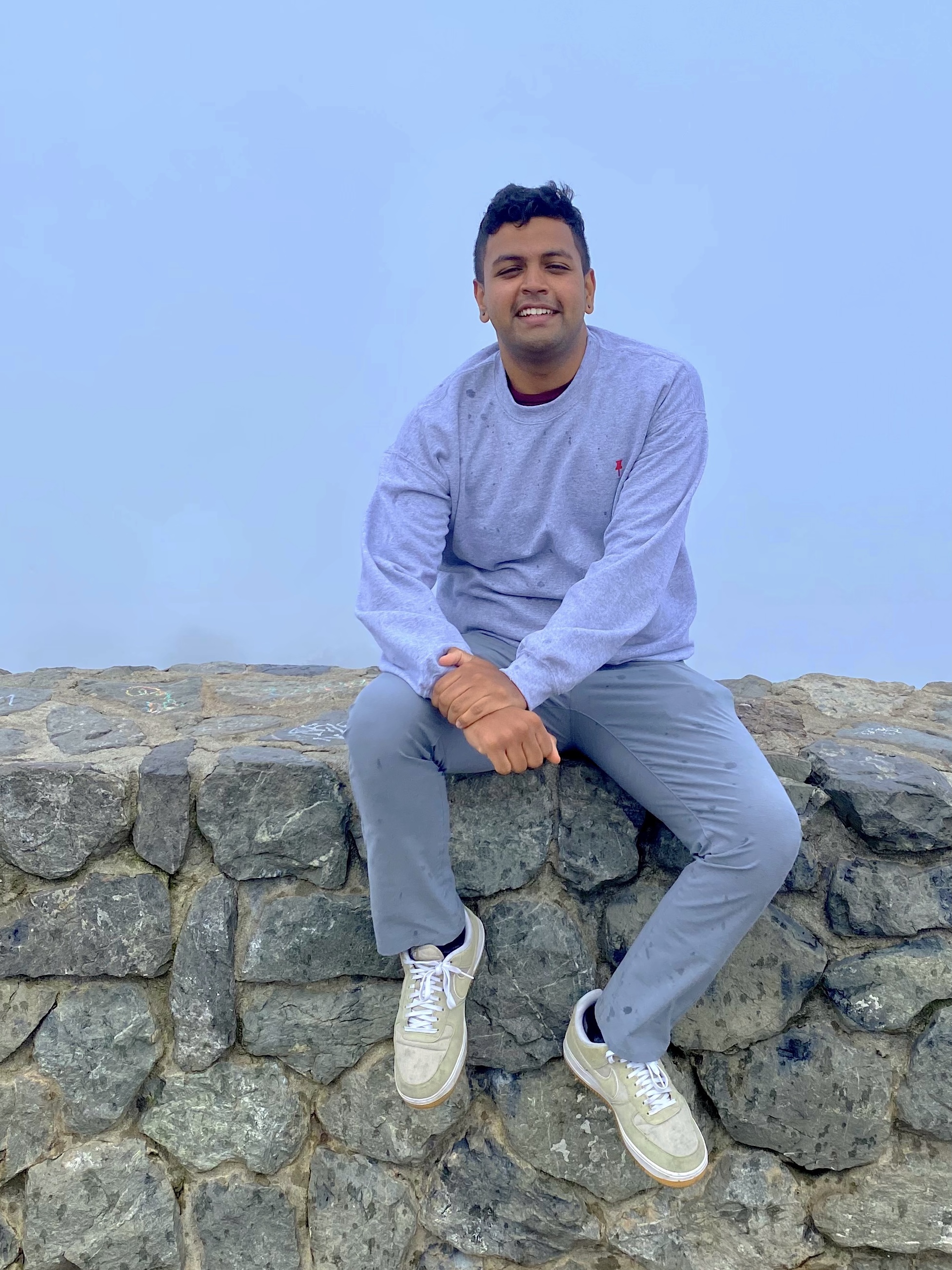 a person sitting on a rock wall