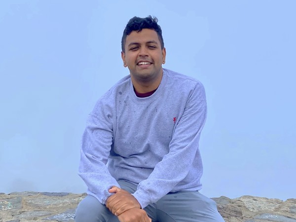 a person sitting on a rock wall