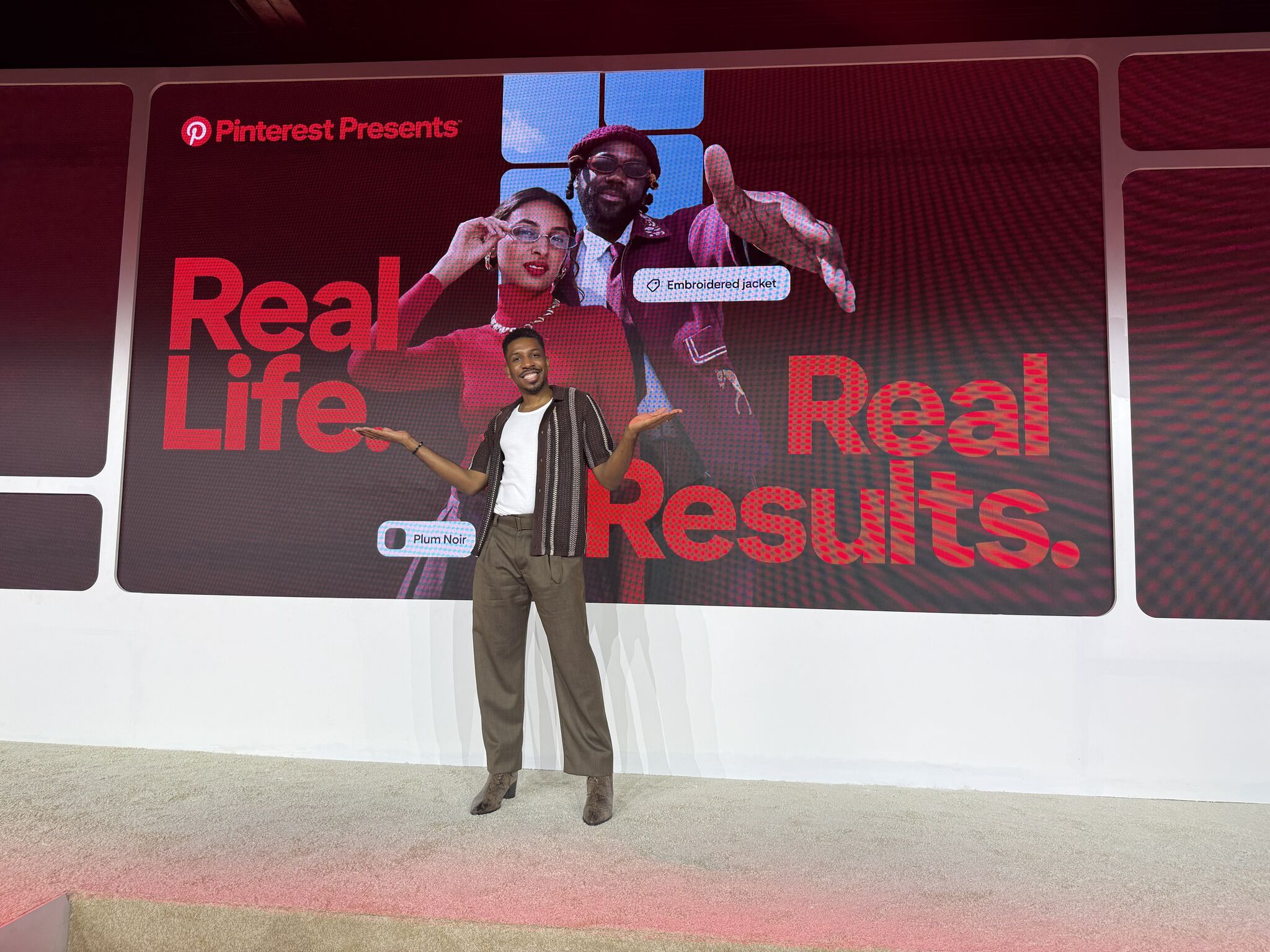 a person standing in front of a large screen