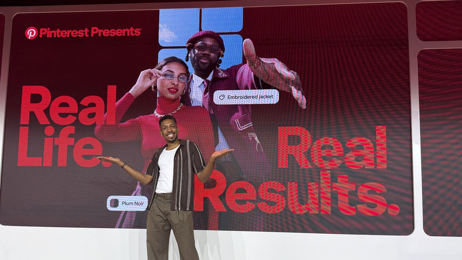 a person standing in front of a large screen