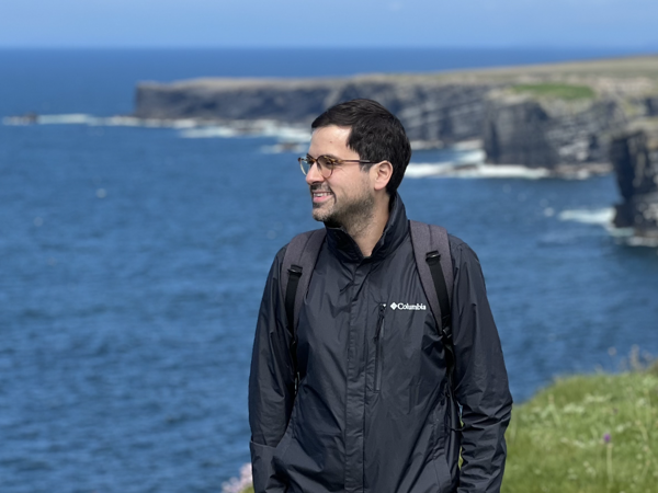 a person standing on a cliff overlooking a body of water