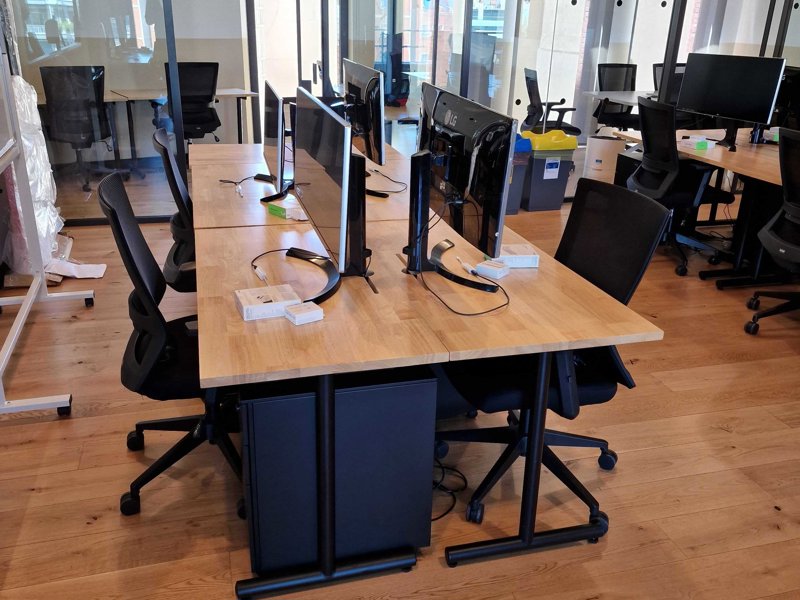 a room with computers and chairs