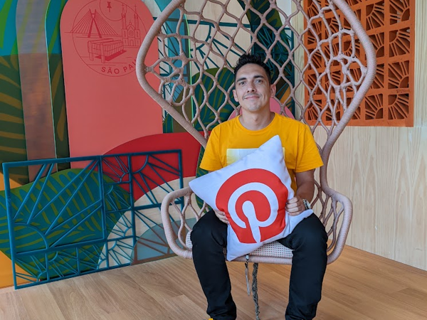 a man sitting in a chair holding a pillow