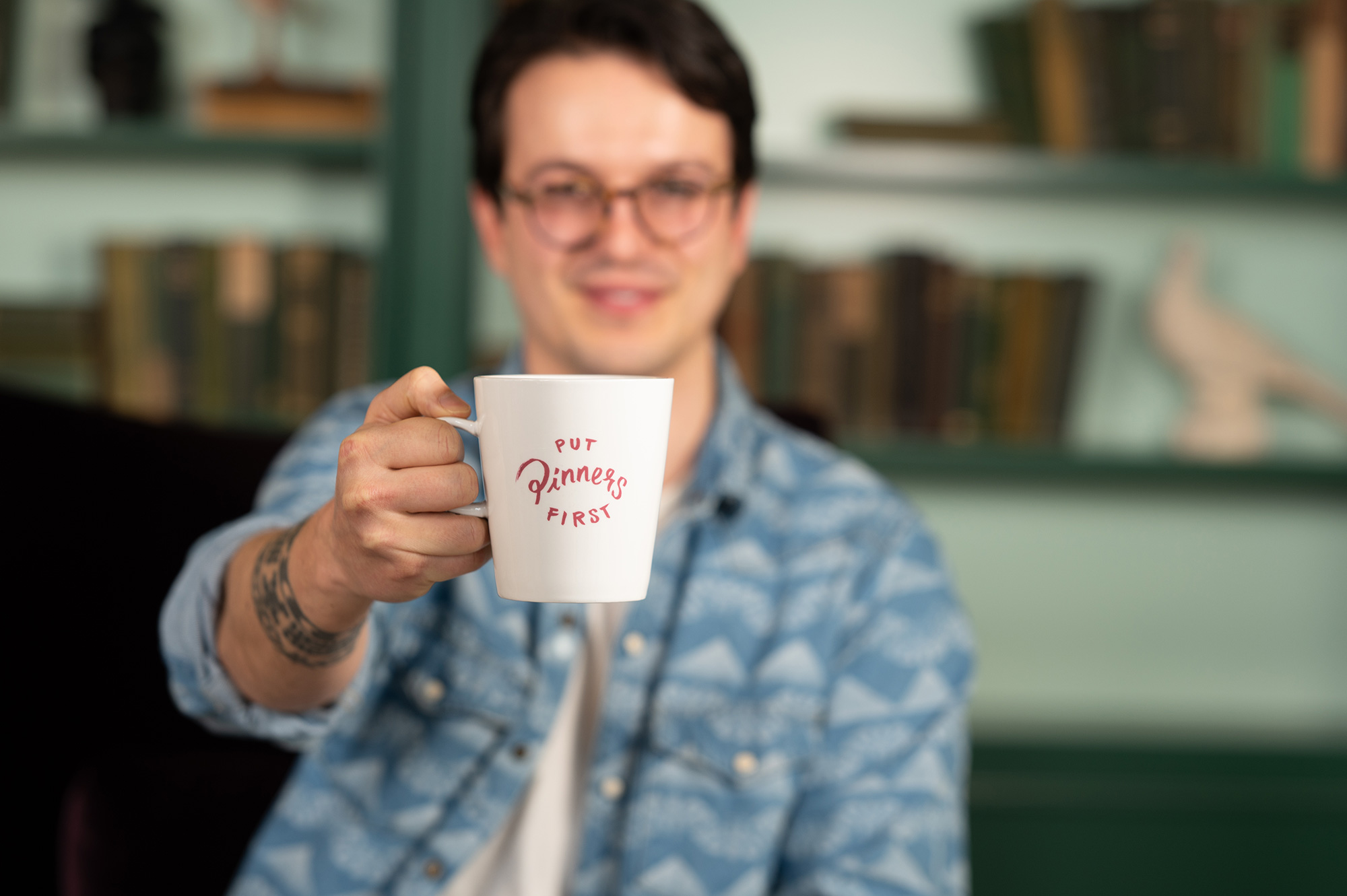 a man holding a white mug