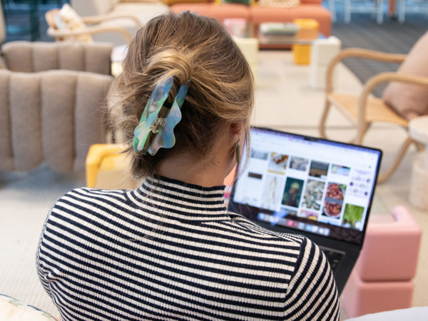 a person sitting on a couch using a laptop