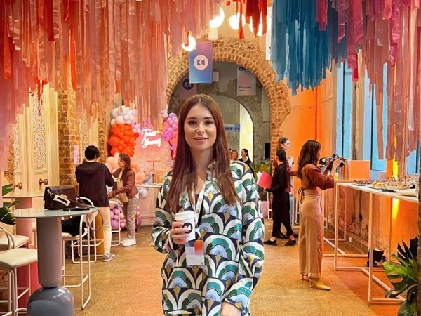 a woman holding a cup of coffee