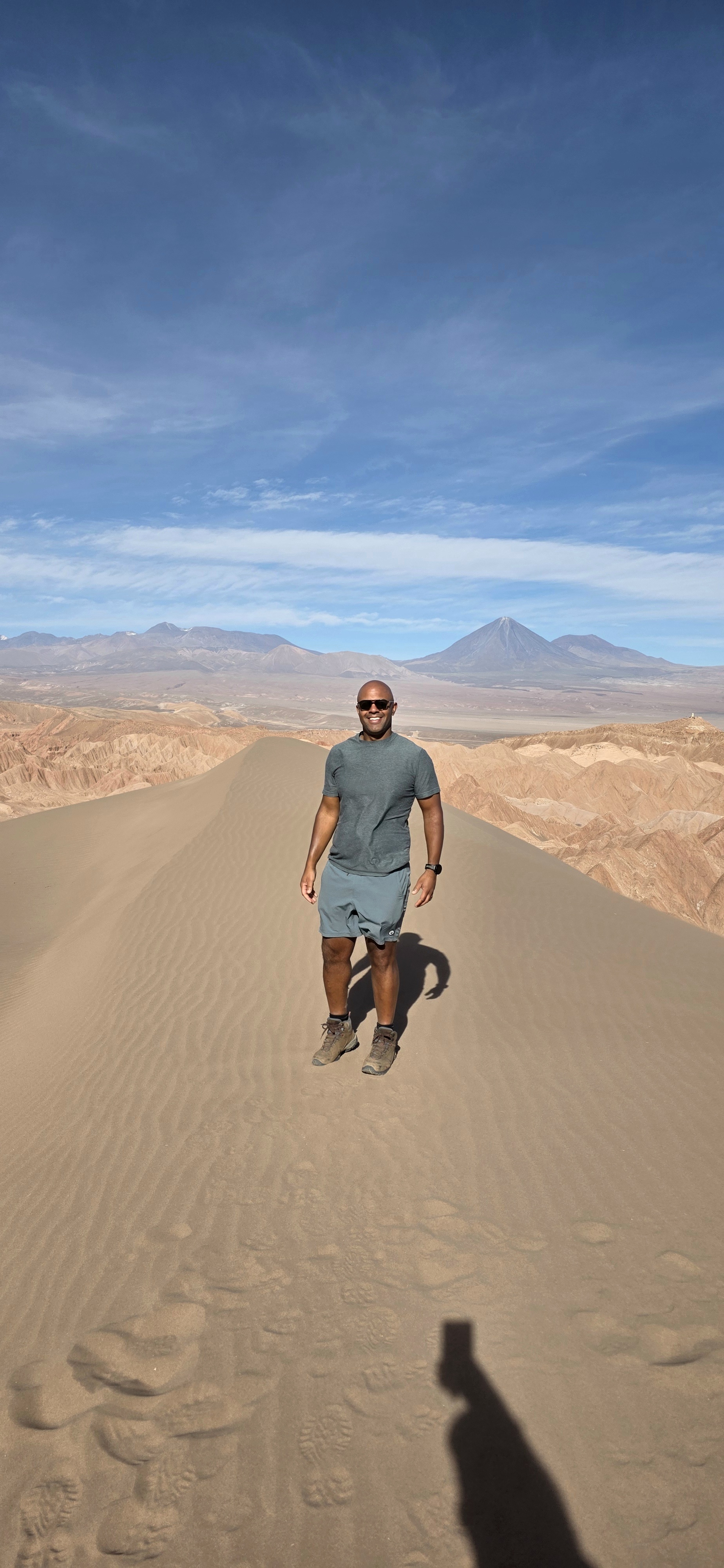 a person standing on a desert dune