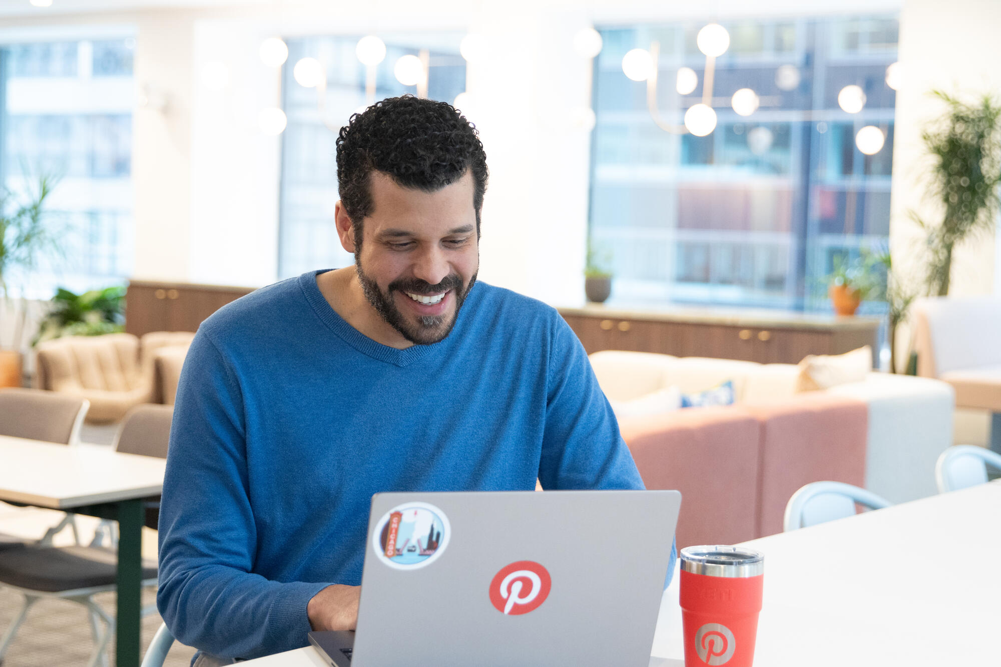 a person sitting at a table with a laptop