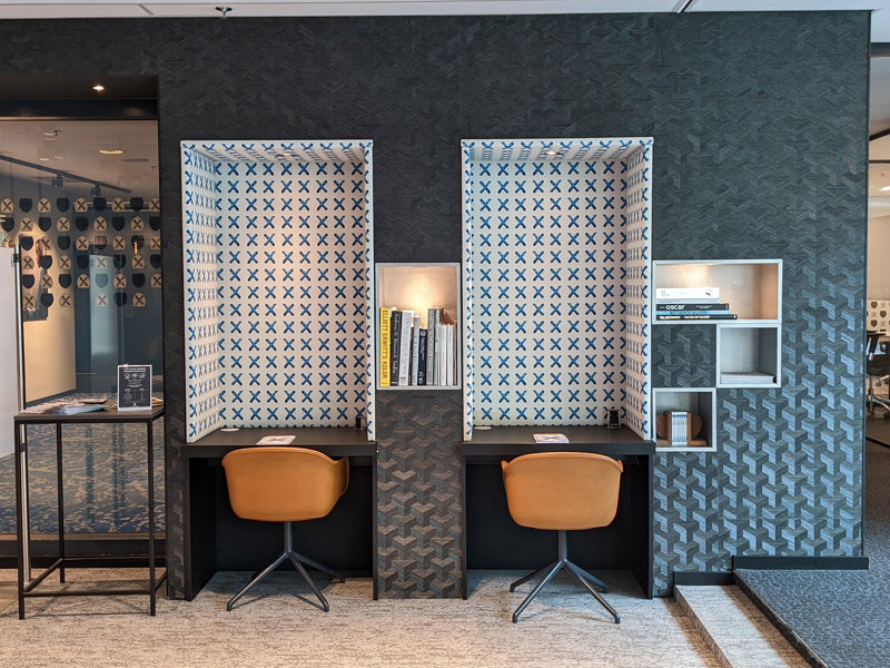 a room with two desks and shelves