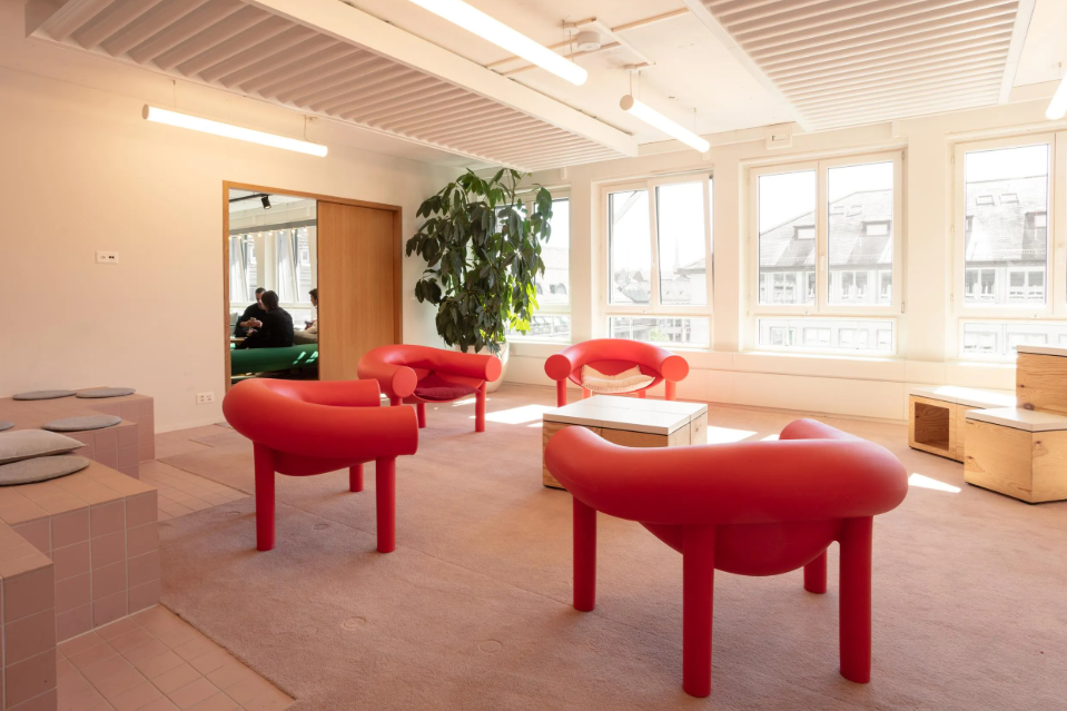 a room with red chairs and a table